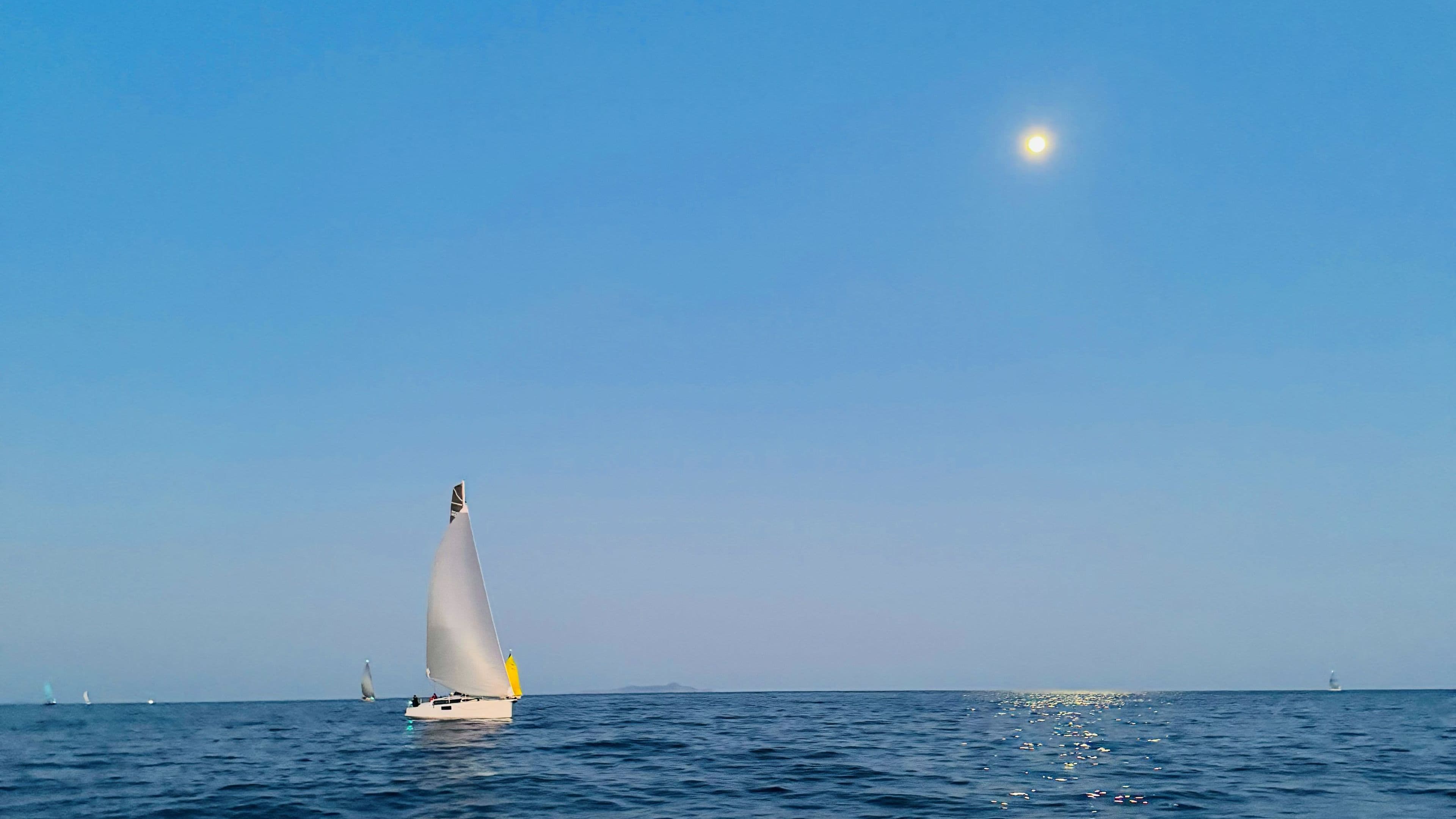 Racing boat under the Moon
